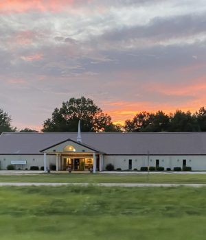 Faith Outreach Church of God building at sunset